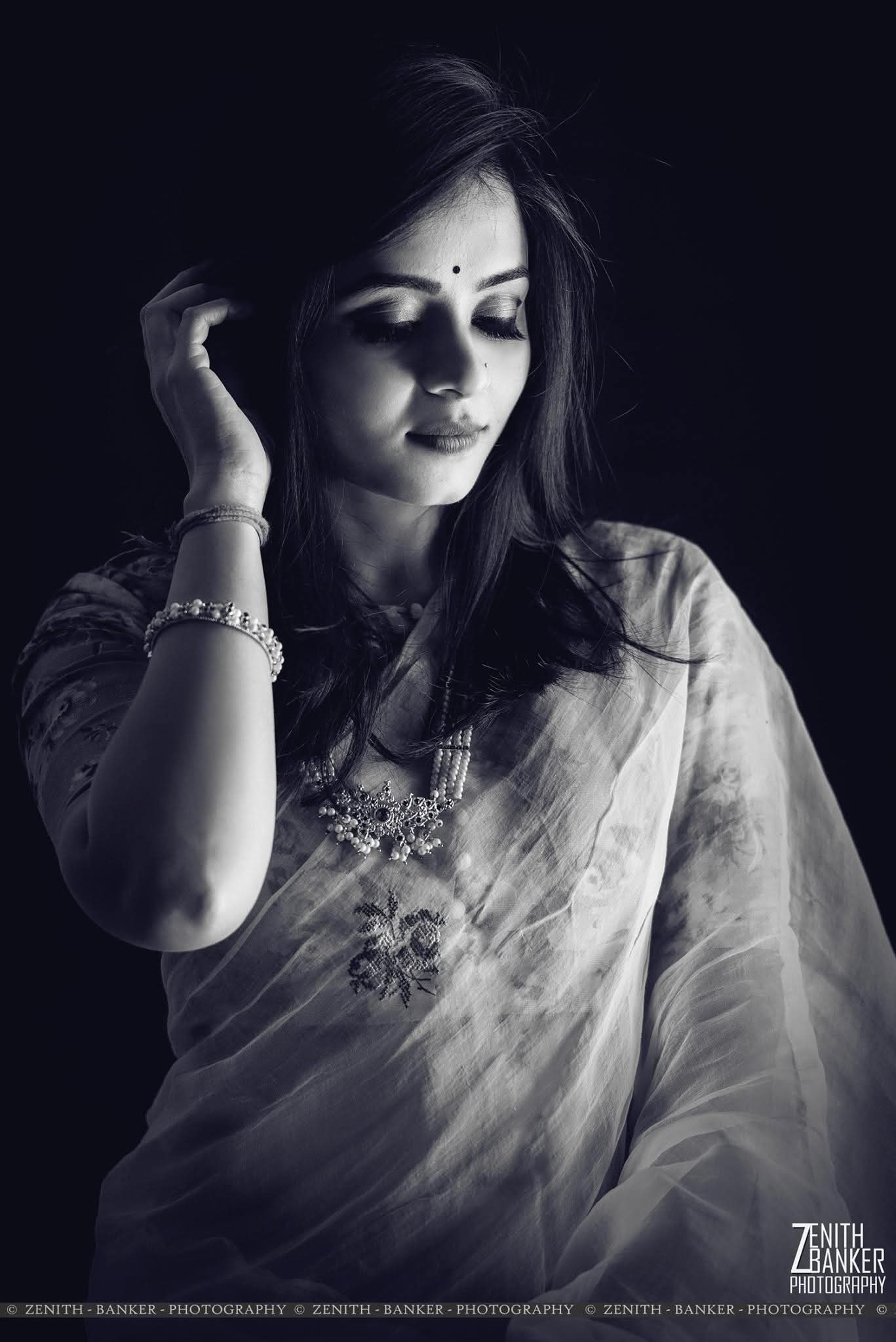 Full-body fashion shot of Radhika Barot wearing a designer outfit in a studio setting.