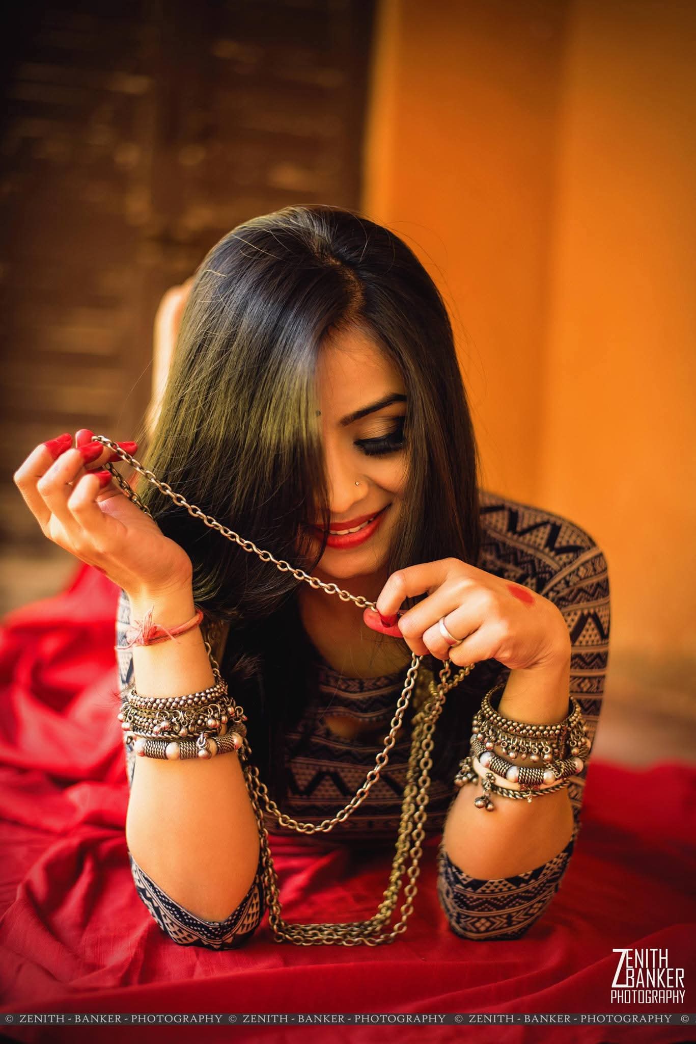 Candid black and white shot of Radhika Barot laughing, looking away from the camera.