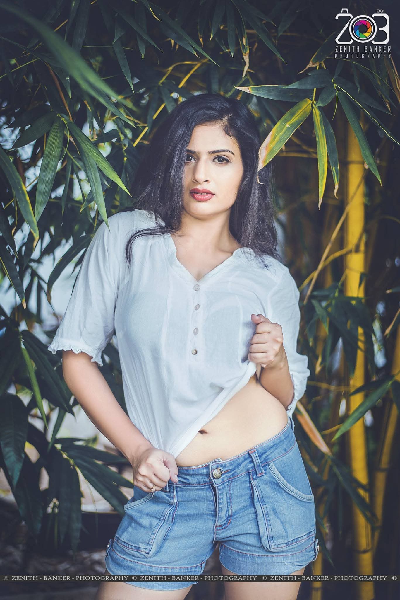 Maulika Patel standing near trees in a traditional/modern outfit during a photoshoot.