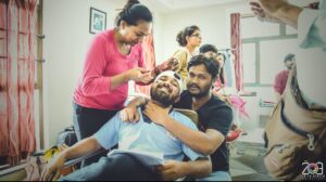 Zenith Banker sharing a candid light moment with actors during a portfolio shoot in Ahmedabad.