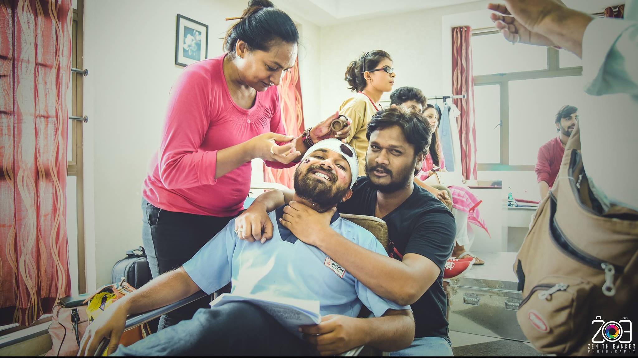 Zenith Banker sharing a candid light moment with actors during a portfolio shoot in Ahmedabad.