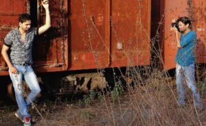 Zenith Banker photographing a modelling actor for a professional portfolio in a studio setting.