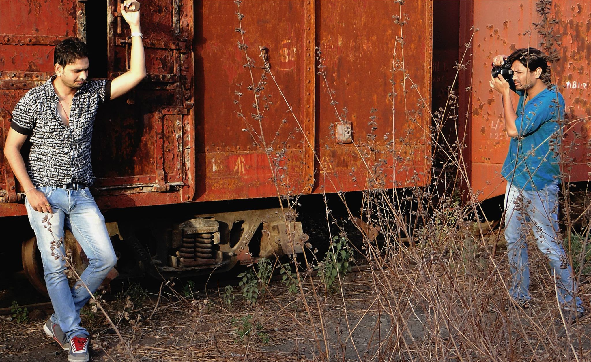 Zenith Banker photographing a modelling actor for a professional portfolio in a studio setting.